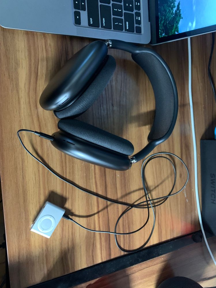 AirPods Max plugged into an iPod shuffle with a cable 