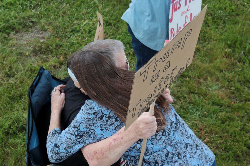 Two protestors embrace, both holding picket signs. The visible picket sign reads: “Trump is a Traitor | Veterans Unite!”.

At 5:00pm on May 7th, 2025, protestors gathered at the intersection of NE Fourth Plain Blvd and NE Andresen Rd outside the Vancouver, WA, Tesla dealership to protest the fascist regime of President Donald Trump and unelected billionaire Elon Musk.
