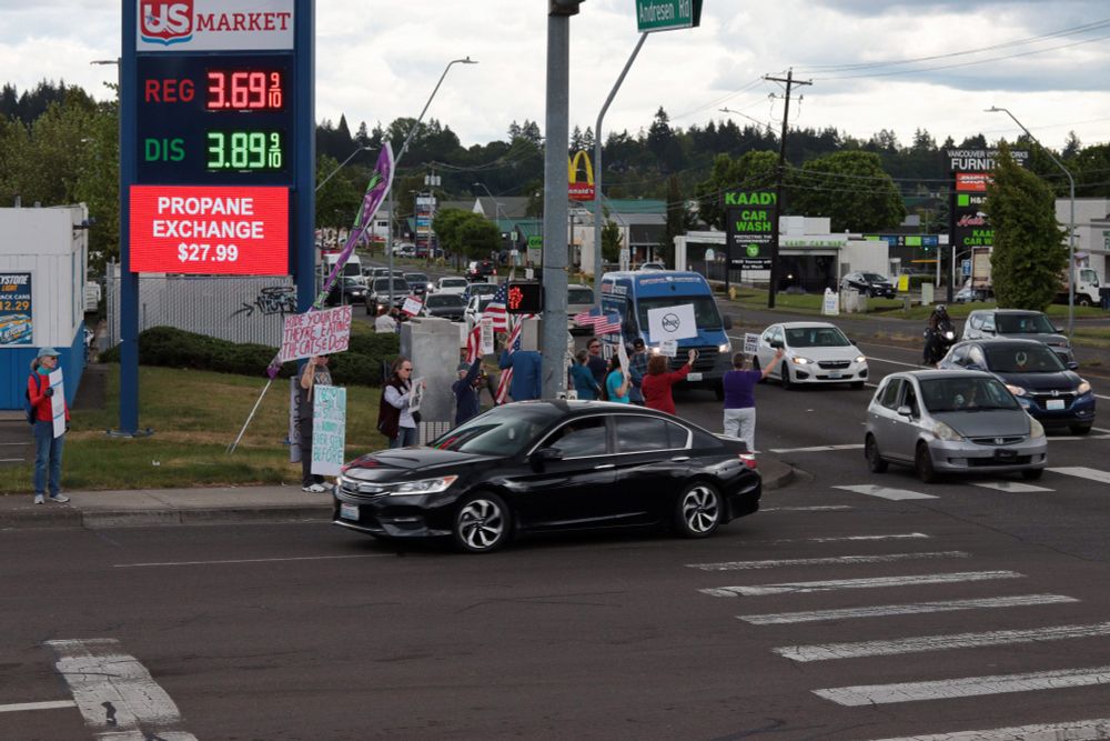 An image of the southeast part of the intersection of NE Andresen Rd and NE Fourth Plain Blvd. Protestors line the sidewalk. A black car is turning onto Fourth Plain eastbound. Behind the black car, many cars can be seen waiting for a green light on Andresen going northbound. 

At 5:00pm on May 7th, 2025, protestors gathered at the intersection of NE Fourth Plain Blvd and NE Andresen Rd outside the Vancouver, WA, Tesla dealership to protest the fascist regime of President Donald Trump and unelected billionaire Elon Musk.
