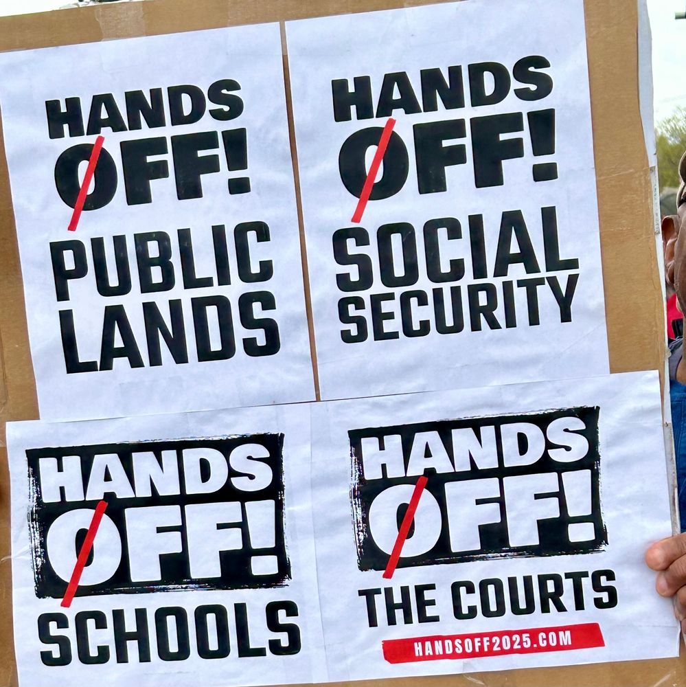 50501 Hands Off protest today in Taos, New Mexico, protest sign “Hands Off! …Public Lands, …Social Security, …Schools, …The Courts” HandsOff2025.com