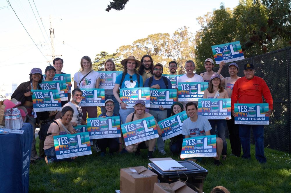20 volunteers holding Yes on L signs