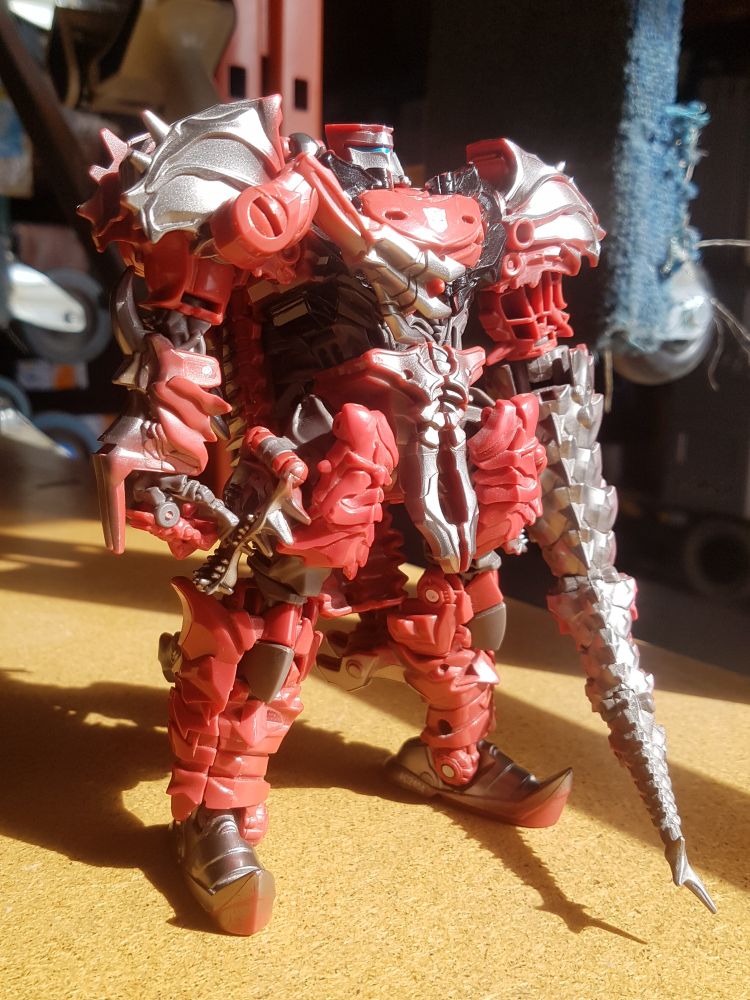 Scorn standing on a workbench in the sunlight.