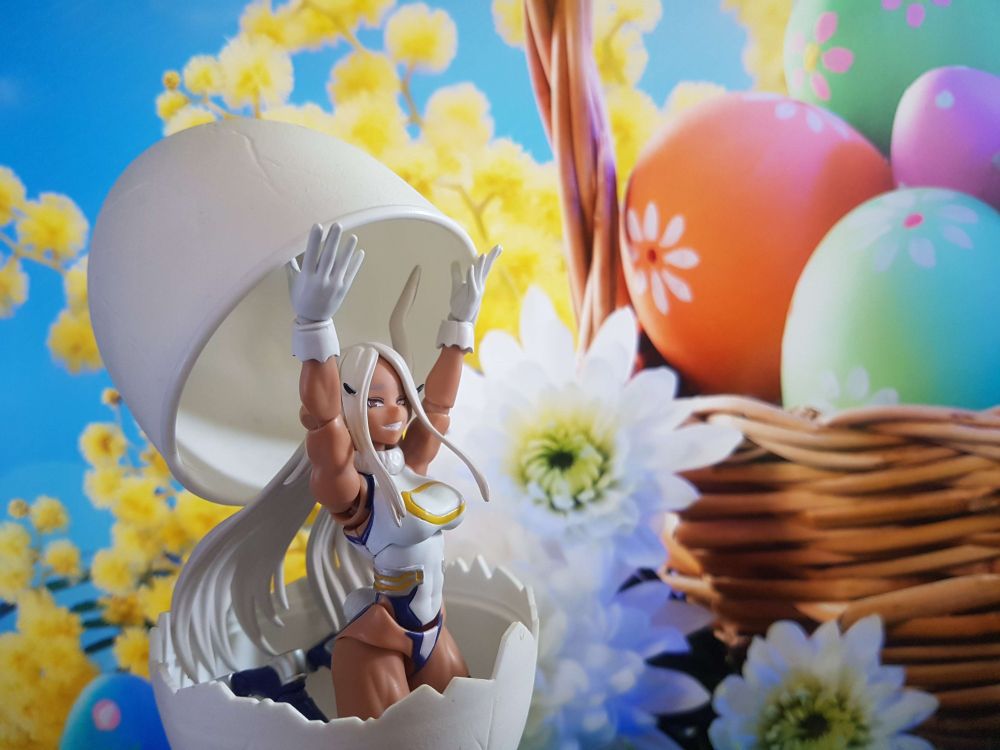 My Hero Academia character Mirko, a bunny themed super hero posing in a large egg with an Easter basket in the background.