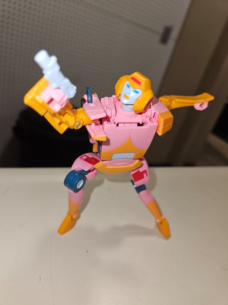 Arcee posed with her pistol ready