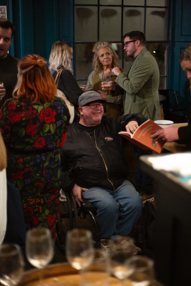 A gentleman smiles as he points at himself in the comic book anthology