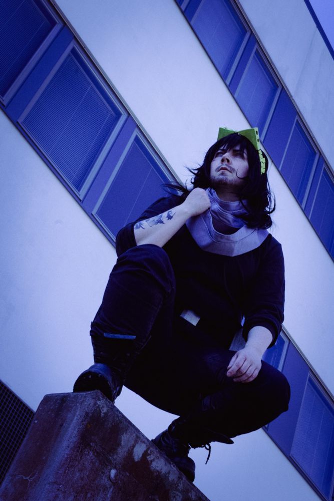 Cosplay picture of Aizawa Shoto from My hero academia. I'm crouch on a wall holding scarf. Picture mood is cold, but epic.