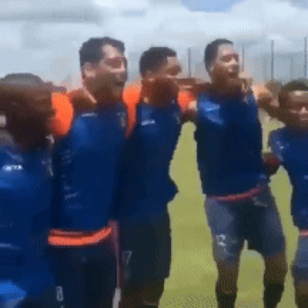 a group of soccer players wearing blue jerseys and shorts are standing together on a field