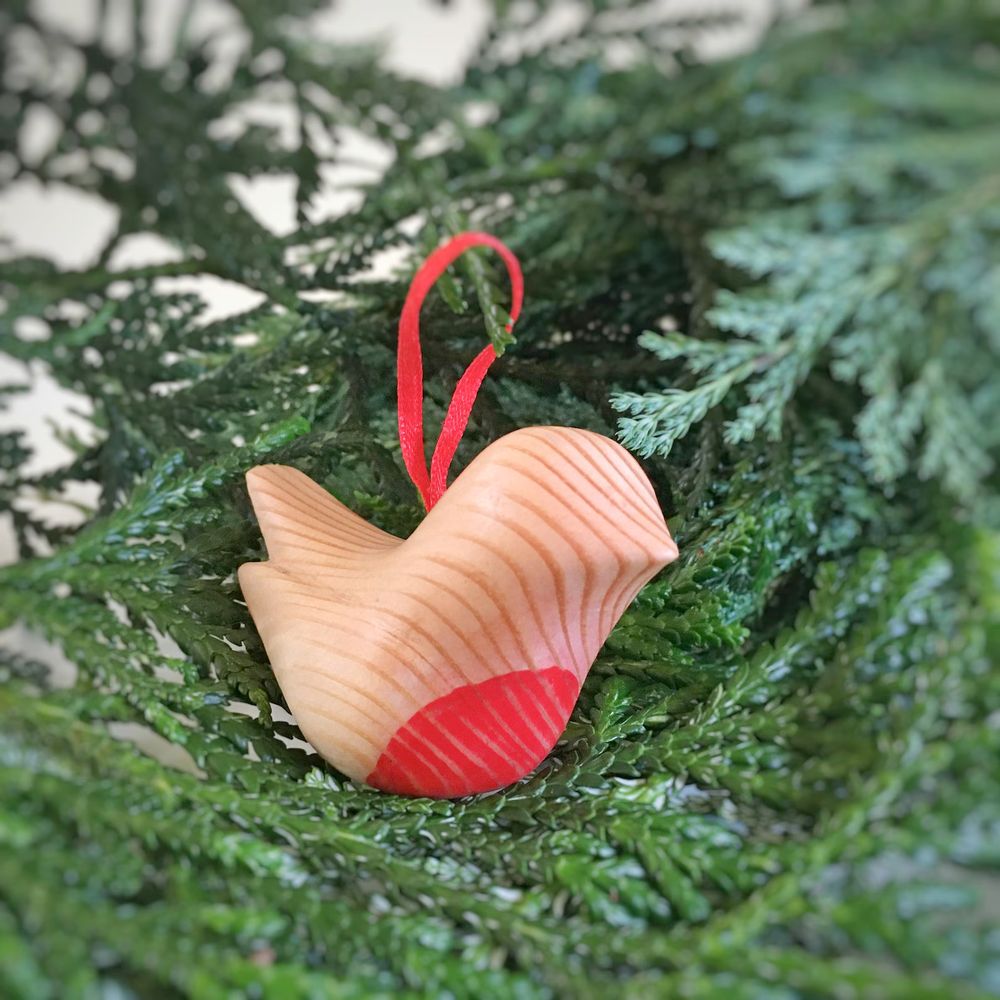 robin ornament carved from wood with painted red belly