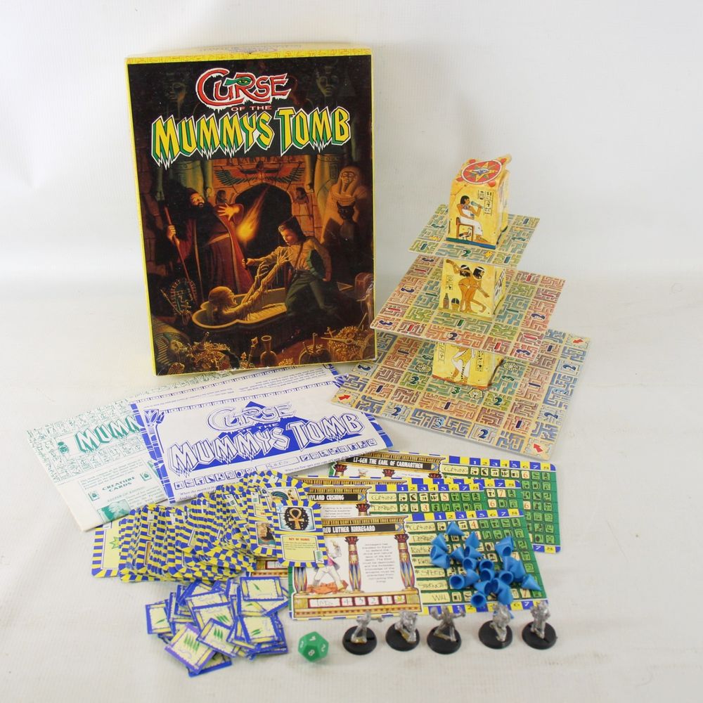 curse of the mummy's tomb board game set up with tower board, cards and miniatures