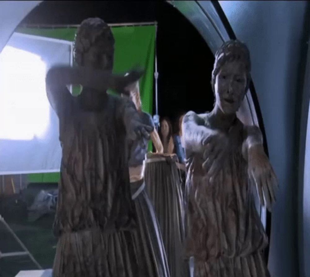 a statue of a woman with a green screen in the background