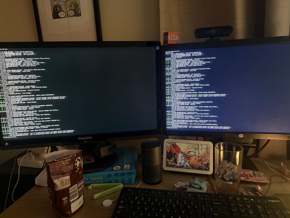 my computer desk showing both monitors booting linux mint (from USB)