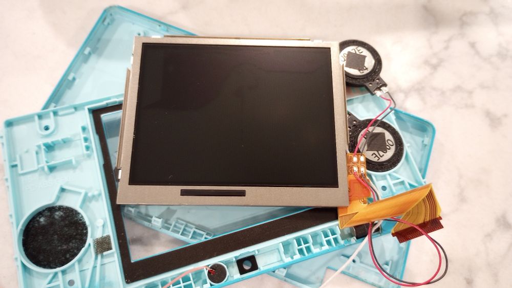 Nintendo DSi top screen disassembled.
Check damage in the entire top left quarter of the screen.