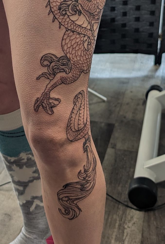 The same tattoo but closer detail of the front of just above and just below the knee