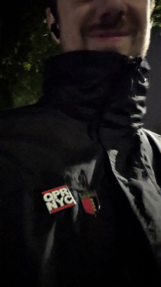 A happy QPR fan showing off his (unbeaten) QPR New York and Libertines badges