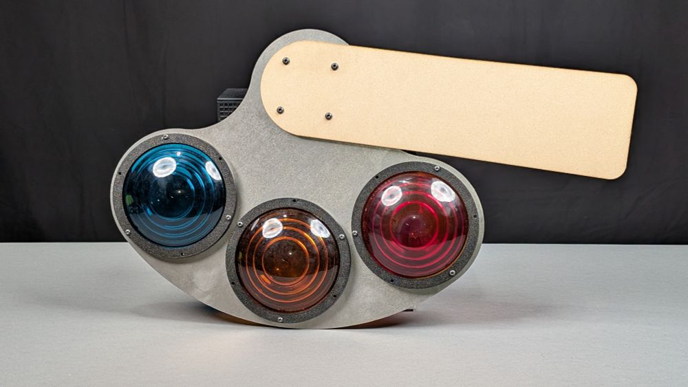small railroad semaphore signal spectacle with a wooden arm and green/yellow/red 4.5" vintage lenses. laser cut from steel and wood with 3d printed plastic retaining rings for the roundels