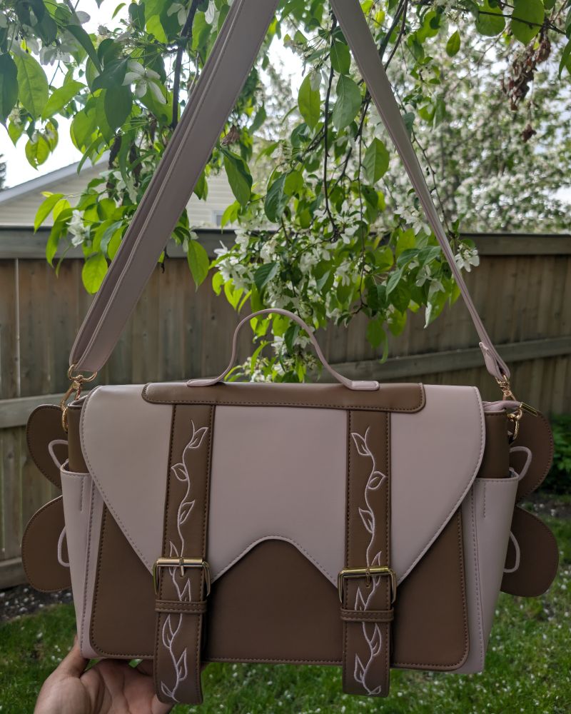 Fairy Convertible Bag hanging on tree (front view)