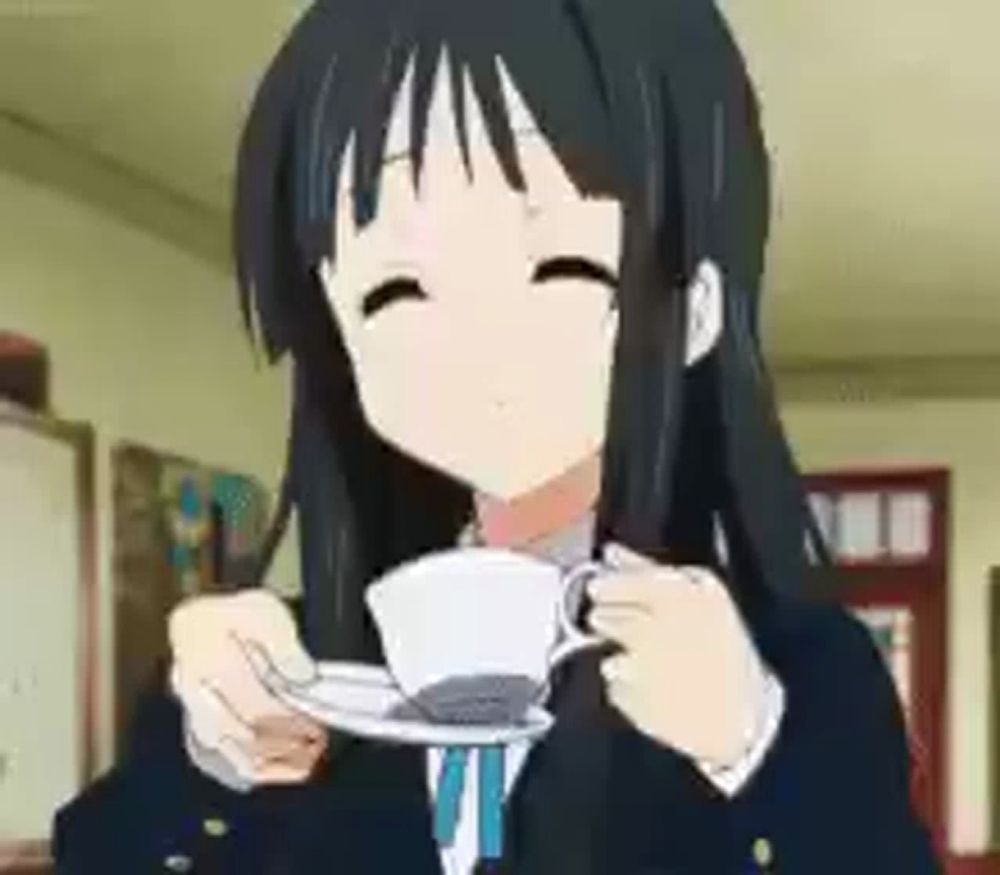 a girl is holding a cup of coffee and smiling .