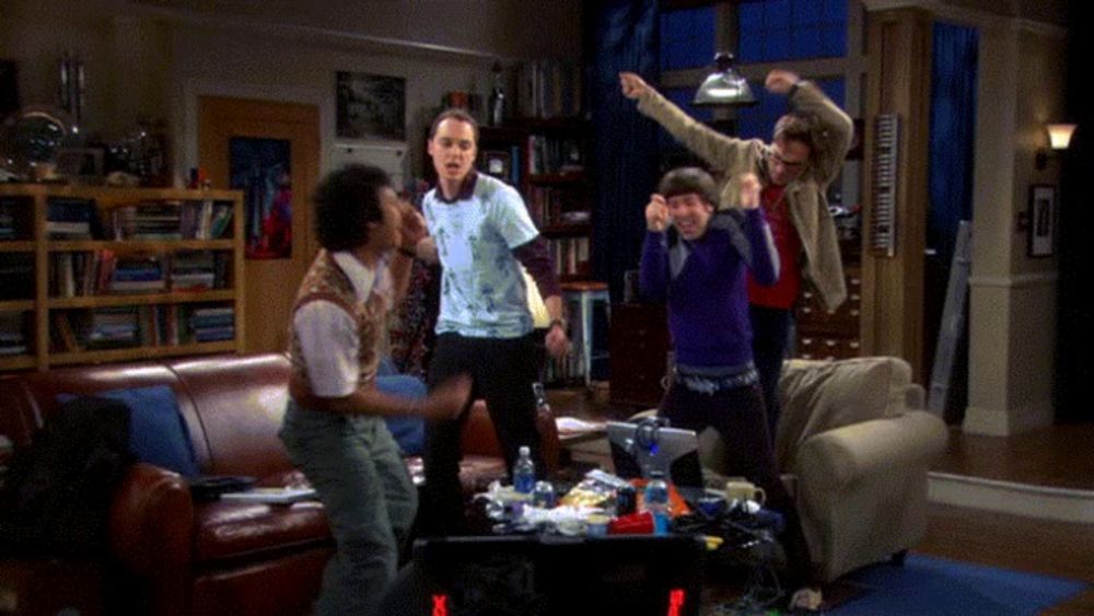 a group of men are dancing in a living room in front of a playstation