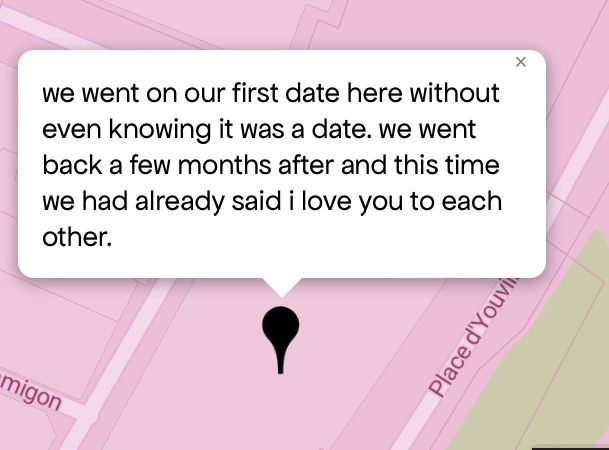 Queering The Map 
Image shows a pink map with a black pin drop on location with message that reads “we went on our first date here without even knowing it was a date. we went back a few months after and this time we had already said i love you to each Other”