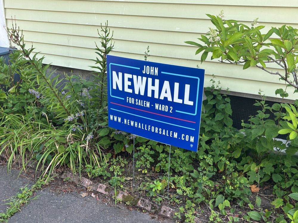 A Newhall for Salem yard sign outside someone's house. The sign reads "John Newhall for Salem - Ward 2, www [dot] newhall for salem [dot] com.