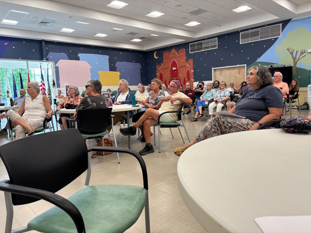 A large crowd sitting and listening.