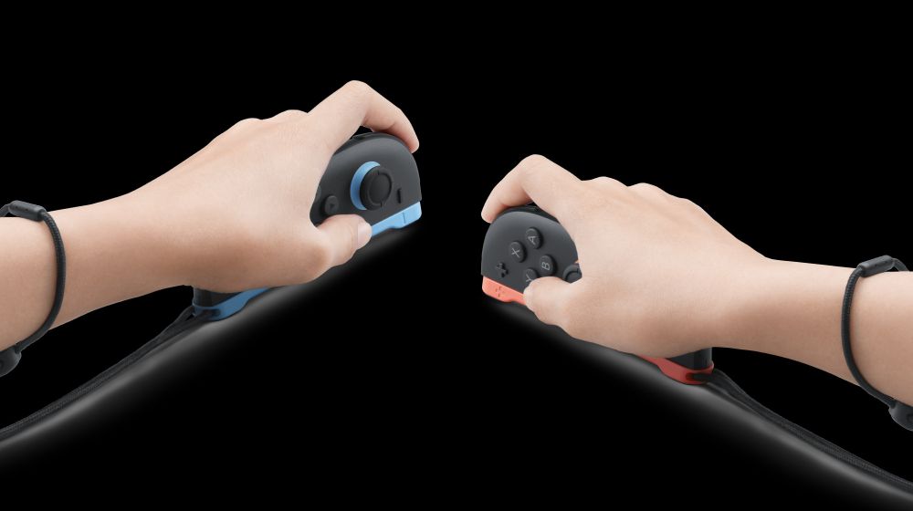 A picture of two hands holding the joycon of the switch 2. The left hand is slightly higher than the right.