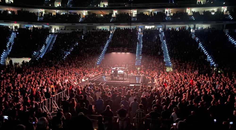 What if everything around you isn't quite as it seems?

Just Trent on the B stage, with the crowd around him illuminated.