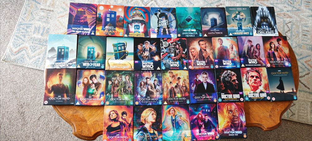A photo showing all the releases of Doctor Who Blu-ray Steelbooks. Top row: The Daleks In Colour, Galaxy 4, The Celestial Toymaker, The Power Of The Daleks, The Underwater Menace, The Macra Terror, The Faceless Ones, and The Evil Of The Daleks. Second row: The Abominable Snowmen, The Web Of Fear Special Edition, Fury From The Deep, Spearhead From Space, Shada, Series 1, 2, 3, and 4. Third row: The Series 4 Specials, Series 5, 6, and 7, the 50th Anniversary Specials, Series 8, 9, 10 and 11. Final row: Series 12, and 13, the Series 13 Specials, the 60th Anniversary Specials, and Series 14(Season 1).