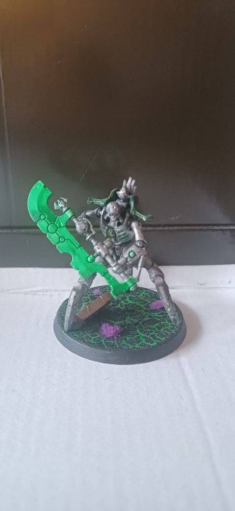 Necron Skorpekh destroyer on a base with cracked black and green earth and purple tuft decoration.