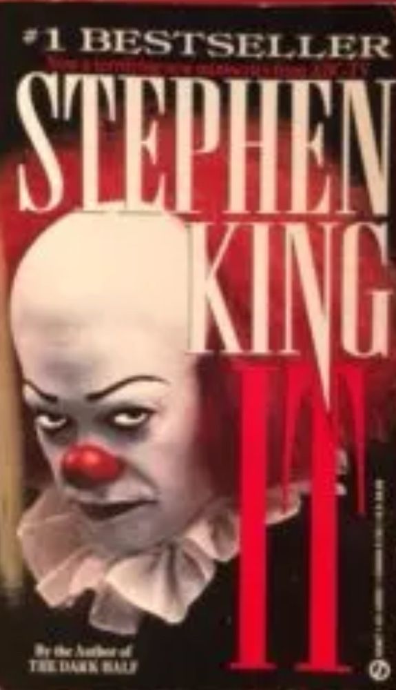 Book cover for Stephen King’s IT. A menacing clown frowns and glowers