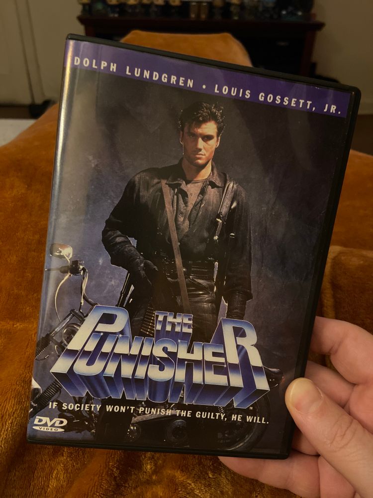 A DVD copy of the best $6 the person holding it has spent, possibly ever. It is Dolph Lundgren in The Punisher (1989). 