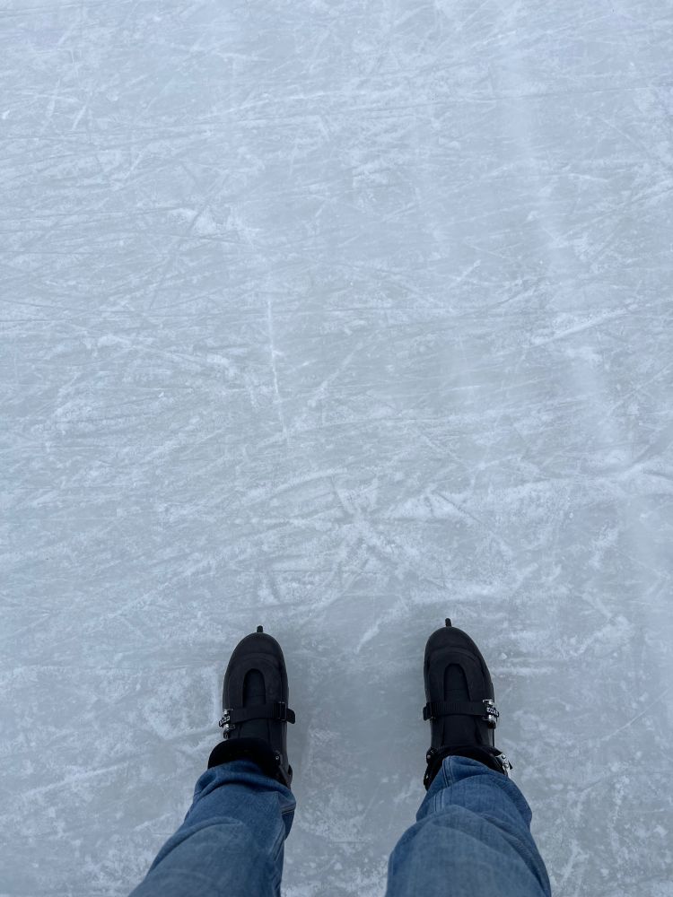 A pair of ice skates on ice, seen from above