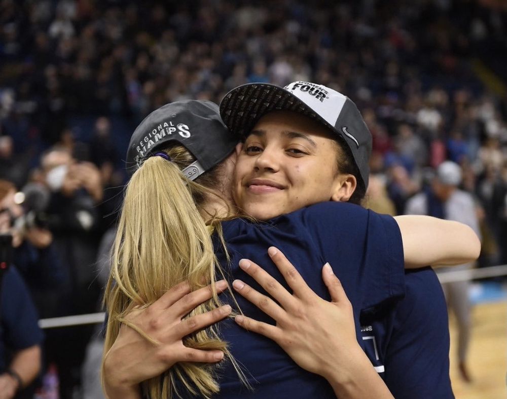 Paige and Azzi hugging wearing regional champs hats