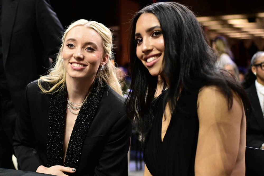 Paige and Azzi sitting at WNBA draft table