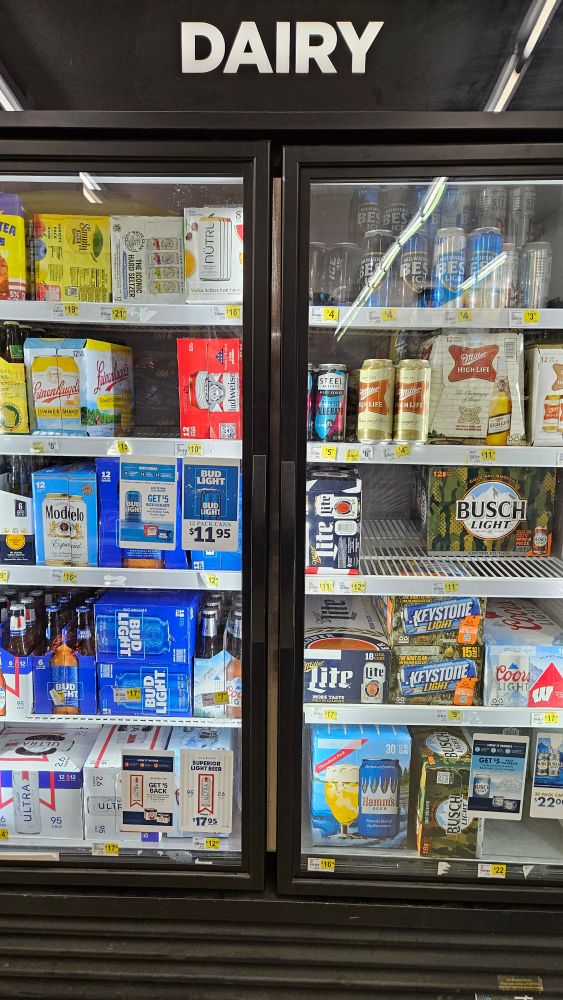 A dairy case full of beer.