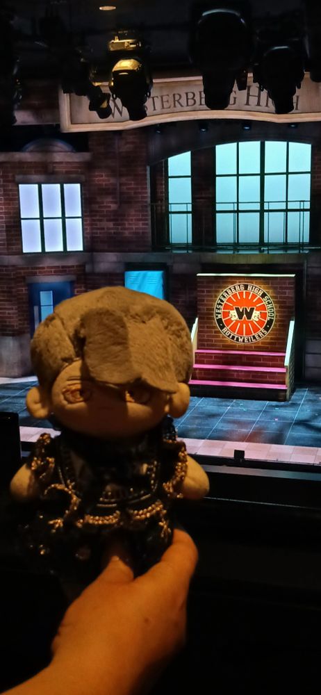 The Narrator in front of the set of Heathers the musical