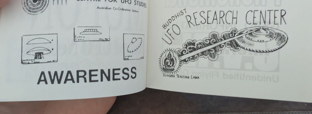 Photo of a book. 
Left: three small UFO photos above the text "AWARENESS"

Right: "BUDDHIST UFO RESEARCH CENTER" text above a UFO shooting a beam at "Sungma Tenzing Lama"