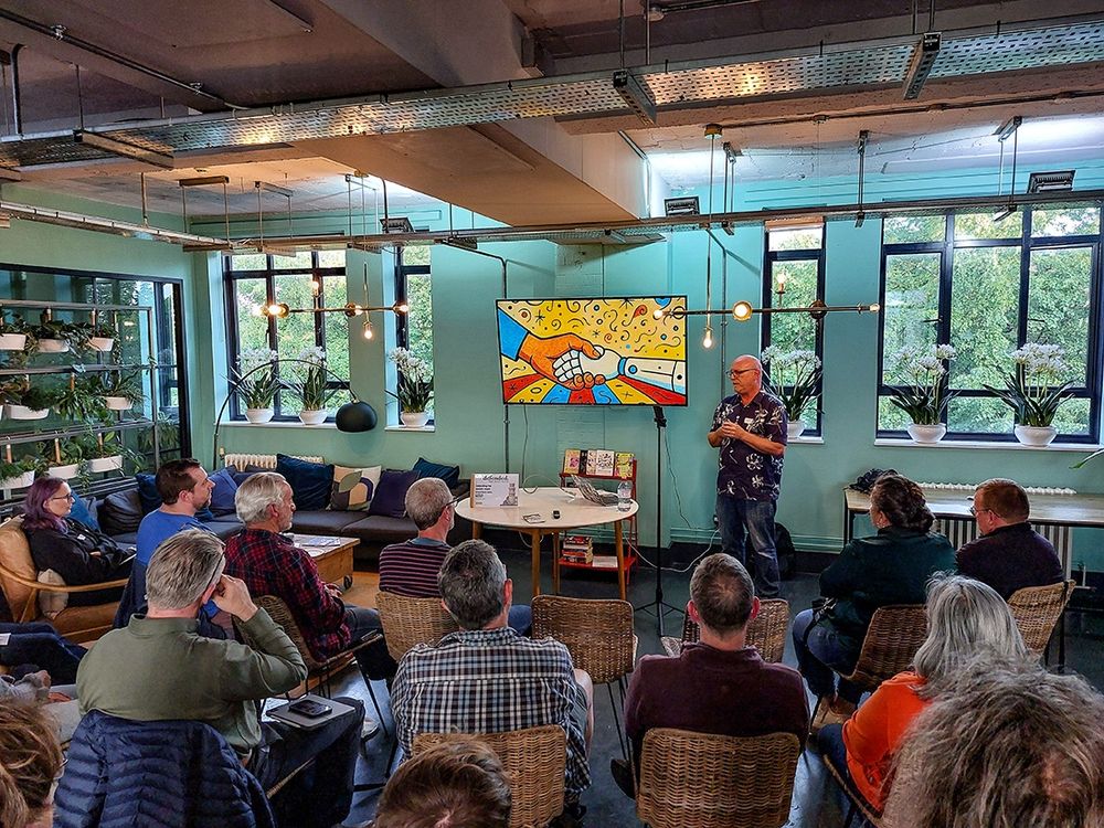 Elliott delivering his talk and showing many people in the audience paying close attention
