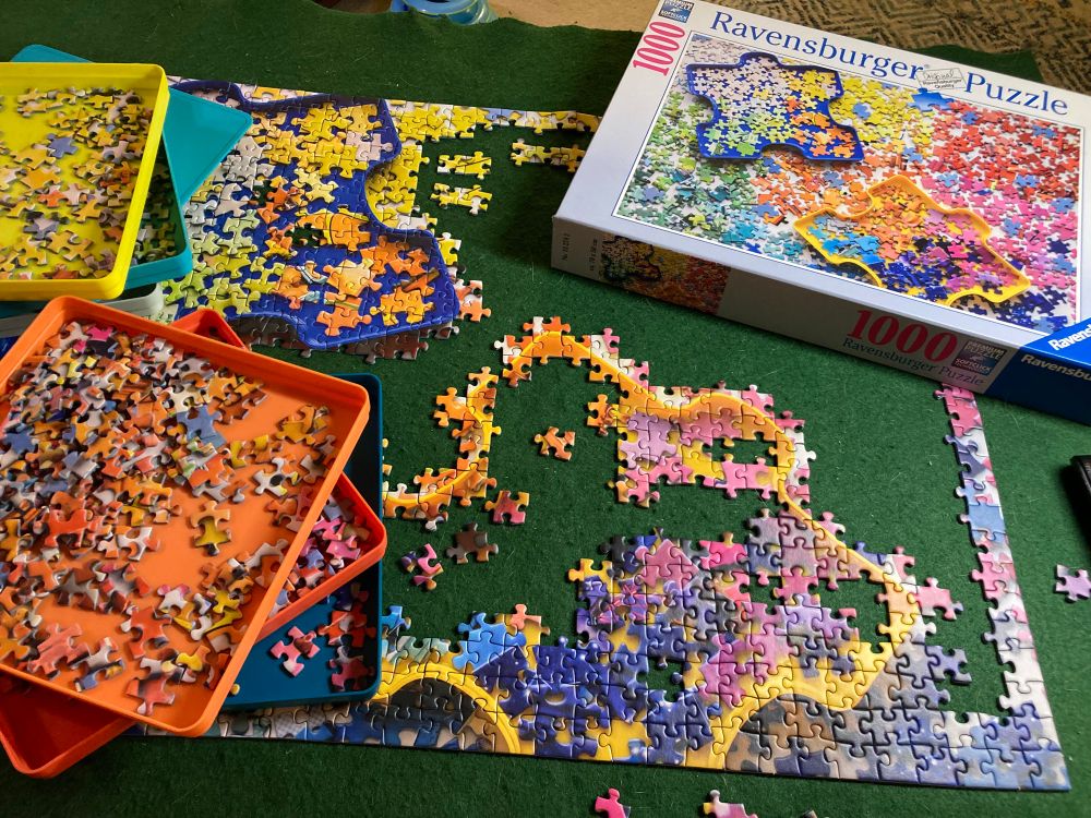 1000 piece puzzle from Ravensburger. The image is a sorted pile of puzzle pieces. 