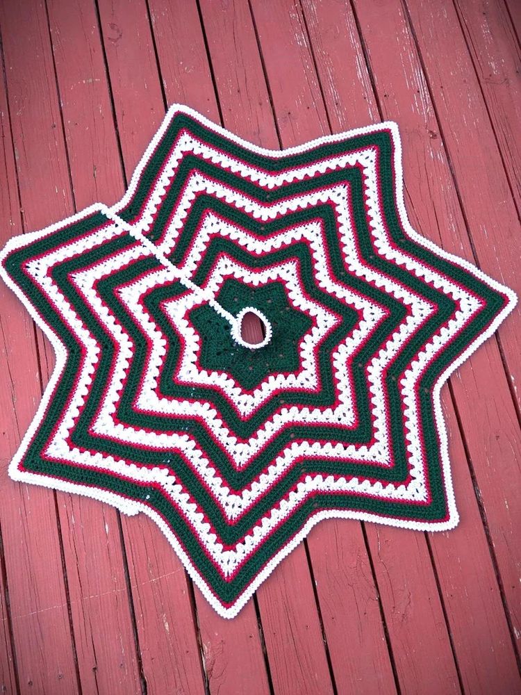 Hand crocheted Christmas tree skirt - star shaped with white, green, and red stripes