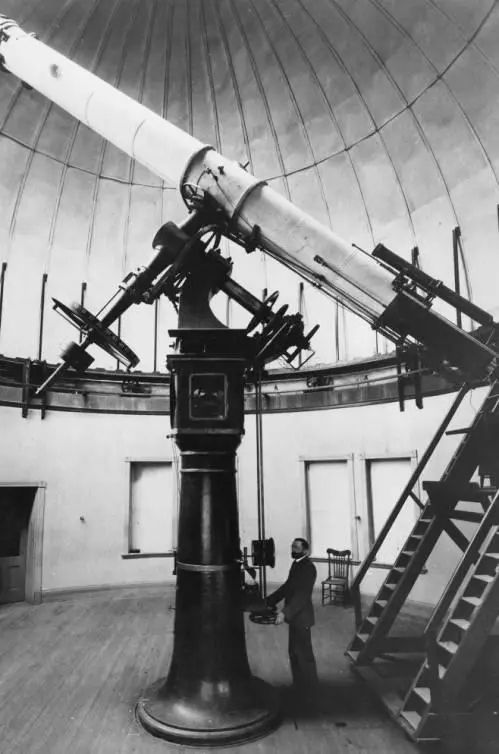 Interior view of Dr. Herbert A. Howe and the 20-inch Clark-Saegmuller refractor telescope inside Chamberlin Observatory (image credit: Denver Public Library Special Collections)