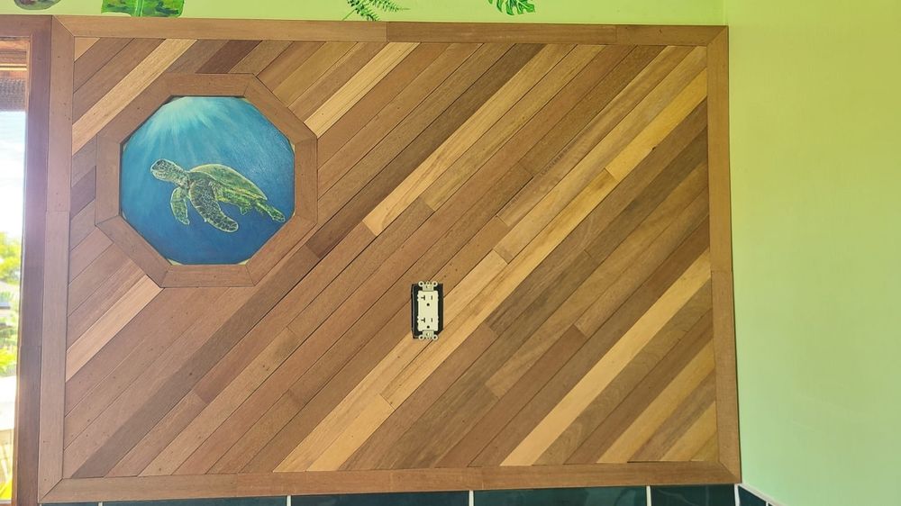 Teak wall with a small octagonal "window" with a placeholder painting of a sea turtle.