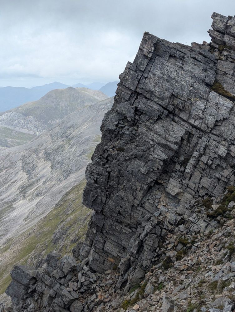 Rocky crags with mountains beyond 