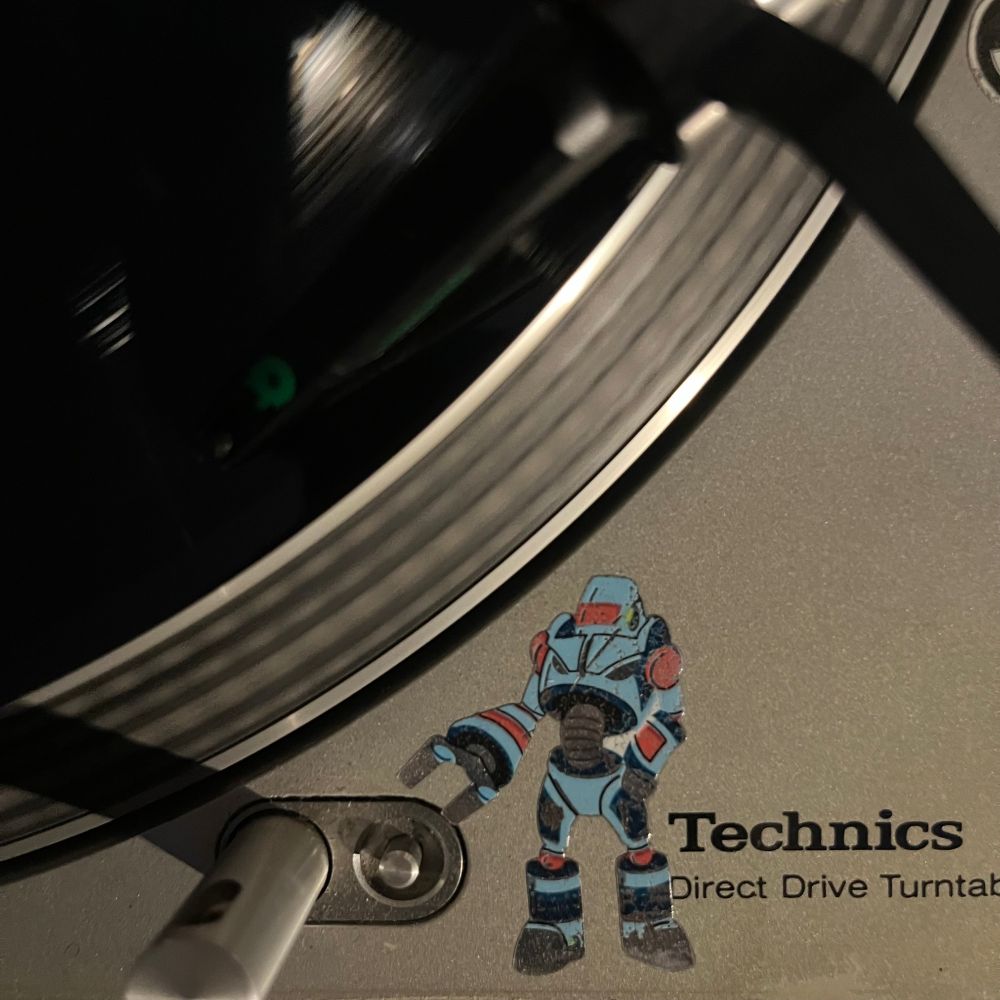 Technics 1200 turntable close up with a non regulation robot sticker
