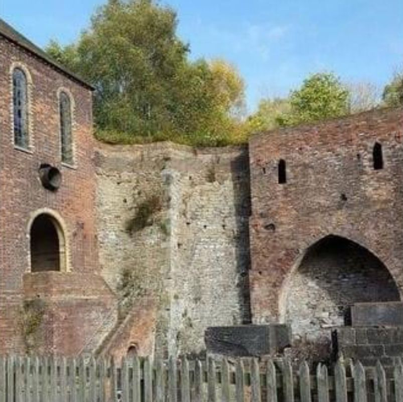 Two old brick buildings face each other and both look surprised