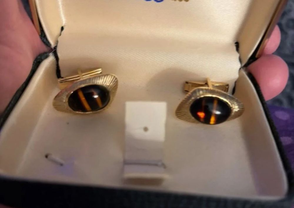 Cufflinks in a box look like a face