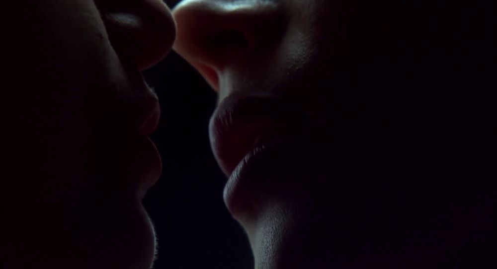 Frame from the neo-noir thriller 'Bound' (1996). Close-up of two women's lips as they're about to kiss each other.