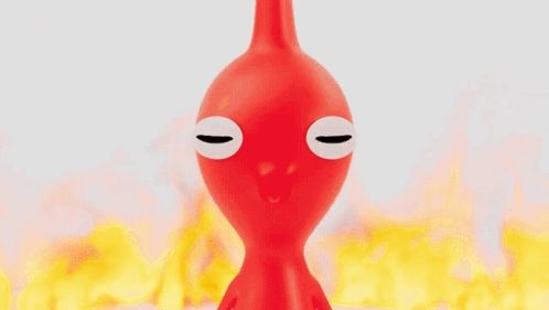 a red toy with big eyes is in front of flames