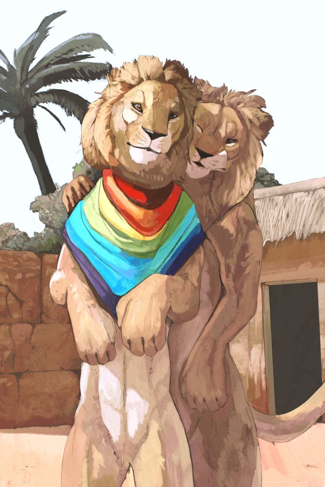 Two lions Infront of some adobe structures, they both stand as one cuddles the other from the back. The one in the front wears a rainbow shawl/scarf