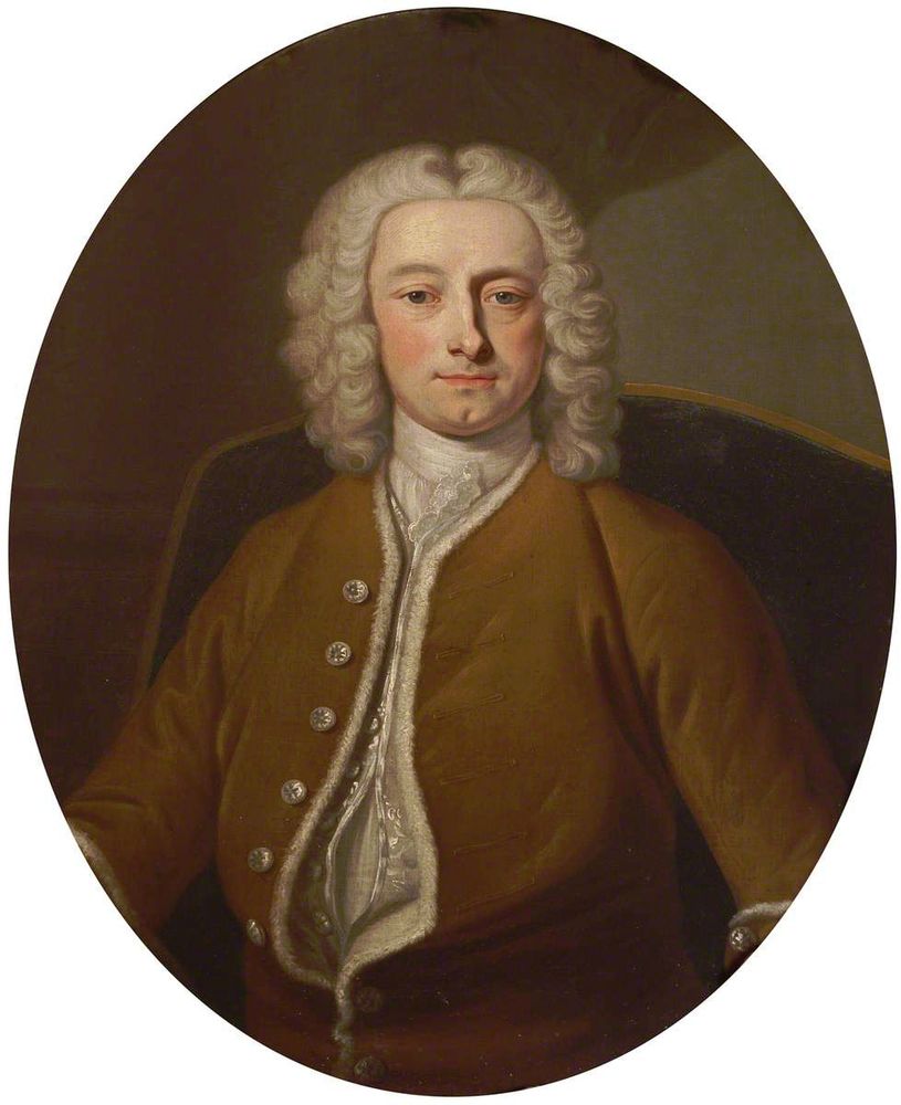 Portrait of a man in 18th-century clothes, wearing a brown coat edged with fur and a shoulder-length curled grey wig. He is seated and gazes directly at the viewer. 